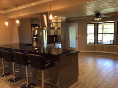 Kitchen counter and dining room with hardwood flooring