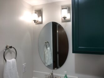 Gorgeous remodeled bathroom with oval mirror